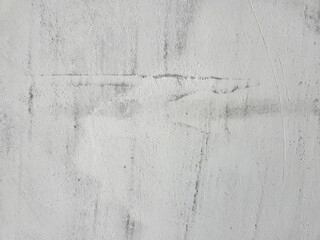 White textured background of putty paste applied with a putty knife with uneven strokes and strokes.