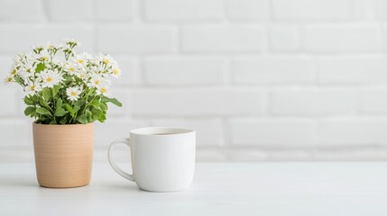 Fototapeta premium White coffee cup and flowers on white table near white brick wall. Possible use for backgrounds, home decor, lifestyle photography