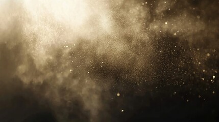 Elegant gold dust particles floating in the air against a deep black background, creating a luxurious effect
