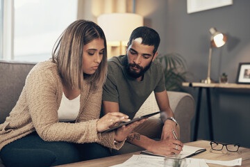 Finance, couple and planning with tablet on sofa for debt management, budget review and online...