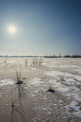 Sand quarry in th Vilnohirsk , Ukraine. Winter landscape on the sand quarry ,sun rays on the sy ,...