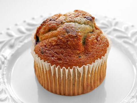 Blueberry Muffin on White Plate with Bright Lighting