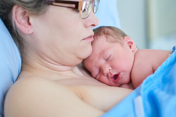 Hospital, motherhood and woman with newborn, childbirth and love for baby on bed, labor and...