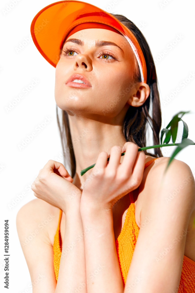 Canvas Prints Bright and Stylish Young Woman in Orange Visor with Green Leaf on White Background