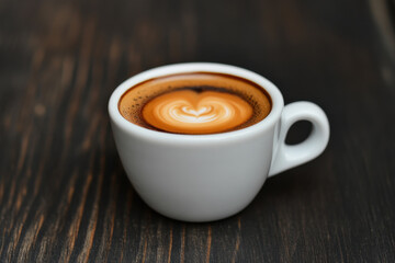 Obraz premium A white coffee cup with a heart shape on top of it