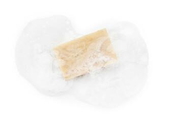 Beige soap with foam on white background, top view
