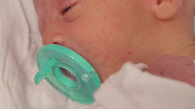 Closeup Newborn Baby Sucking on Pacifier. Shot on a GH5