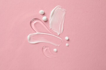 Samples of different cosmetic products on pink background, flat lay