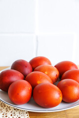 Easter eggs painted using a folk method with onion peels, close-up on a white plate.