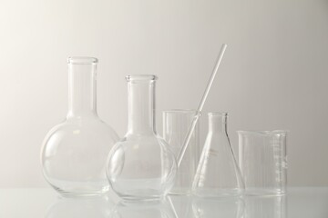 Many different laboratory glassware on light background