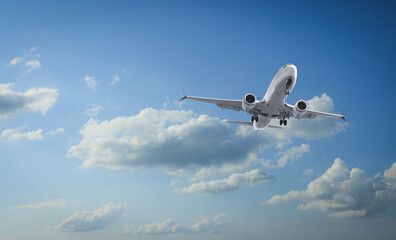 Airplane flying in beautiful blue sky with clouds
