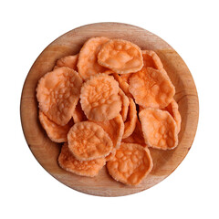 Top view of prawn crackers on wooden plate