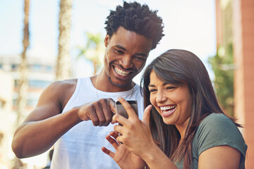 Happy, interracial couple and laughing with phone in city for funny post, social media or joke...