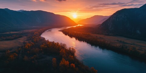 Peaceful river scene with warm sunset colors and mountain backdrop.