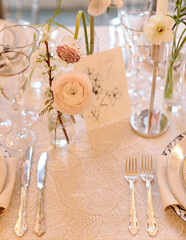 Elegant table setting with flowers and fine dining utensils for a special event at a luxurious venue