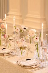 Elegant dining setup adorned with flowers and candles for a special occasion in a sophisticated venue