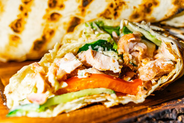 Delicious grilled chicken wrap with fresh vegetables and sauce