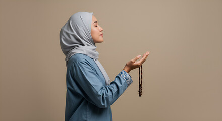indonesian women muslim praying to god by open arm in the studio background