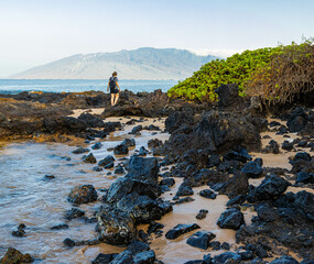 Female Tourist on Exposed Lava at Kamole Beach Park III , Maui, Hawaii, USA