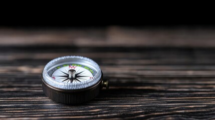 Compass on wooden surface, dark background, direction, guidance, travel concept