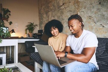 Laptop, laugh and couple on sofa in home for reservation of romantic weekend trip with online hotel...