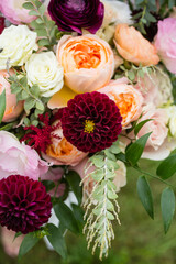 Close-up of a vibrant floral bouquet with roses and dahlias