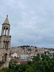 Fototapeta premium cenic view of the historic bell tower in Hvar, Croatia, rising above the charming town with its picturesque stone buildings and stunning Adriatic backdrop.