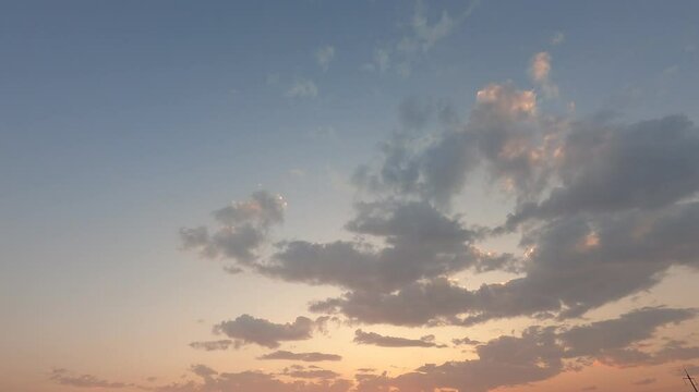 time-lapse sunset sky, cloudscape background. colorful clouds generate powerful energy and environment. wide-angle sky in the sunrise reflects on the cloudscape. peaceful nature background