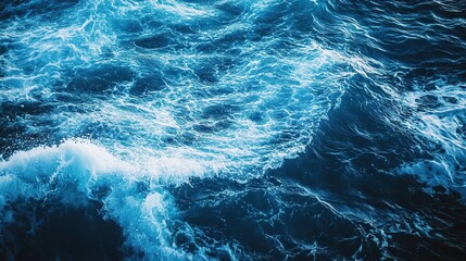 Fototapeta premium Serene blue ocean waves under a bright sun, high-contrast water surface, tranquil seascape with natural beauty.