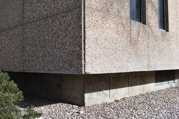 Concrete and stone structure. Corner shot, rocks surrounding the foundation.