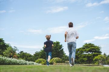 Fototapeta premium Happy family parent children having picnic outdoor activity. Enjoy happiness moment summer playing together including father mother son and daughter relaxing in the morning sunrise.
