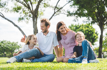Fototapeta premium Happy family parent children having picnic outdoor activity. Enjoy happiness moment summer playing together including father mother son and daughter relaxing in the morning sunrise.