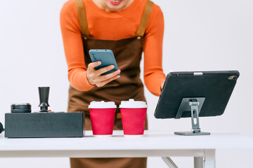A professional barista wearing overalls prepares coffee using a coffee maker and drip kettle,showcasing alternative brewing methods, precision,passion for crafting high-quality beverages in a cafe