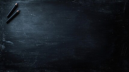 Black Chalkboard Background with Two Black Pencils on the Upper Left Corner for Creative Educational and Artistic Designs