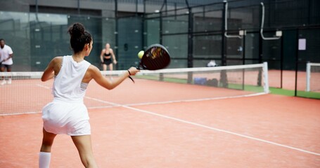 Sport, girl and playing tennis on court with serving ball, competition match and tournament challenge. Padel player, athlete and fitness with racket for club practice, skills training and performance