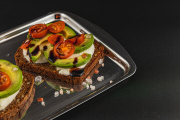 Delicious open-faced sandwich with fresh vegetables on dark bread
