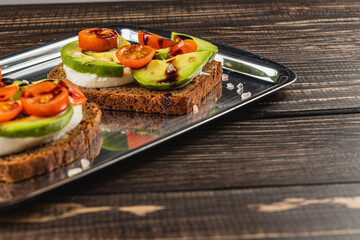 Delicious open-faced sandwiches with fresh vegetables on rustic bread