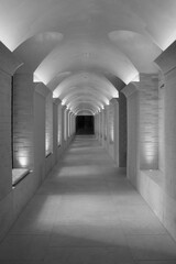 Endless Symmetry: Black and White Arched Corridor with Soft Lighting