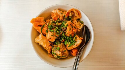 Hearty bowl of Bakso Malang featuring tofu, meatballs, and wontons
