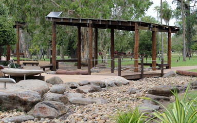Shelter hut with a dry creek bed and trees at Plantation Park in Ayr, Queensland, Australia