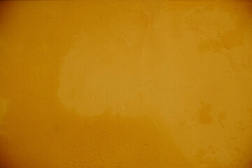 Vibrant Ochre Yellow Wall Showing Rough Textured Plaster
