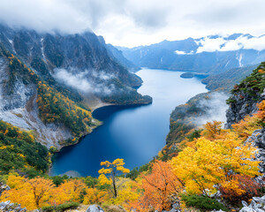 Obraz premium Autumnal lake nestled in misty mountains, scenic vista
