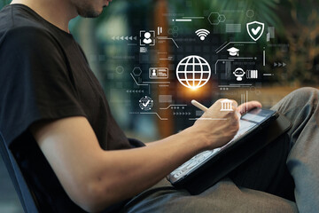 A young man writing on a tablet, with digital icons related to technology, education, and networking.