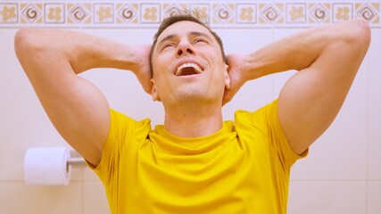 Man feeling relaxed and satisfied on the toilet