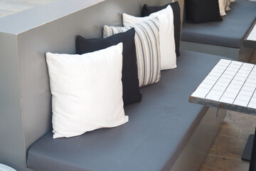 Comfortable seating area with decorative cushions in modern cafe