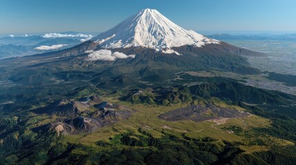 Fototapeta premium Majestic view of snow-capped mountain with lush green valleys and clear blue skies