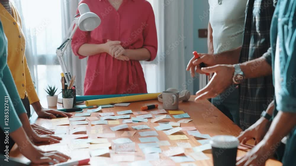 Poster top view of business team write graphic logo on meeting table with colorful sticky notes and design 