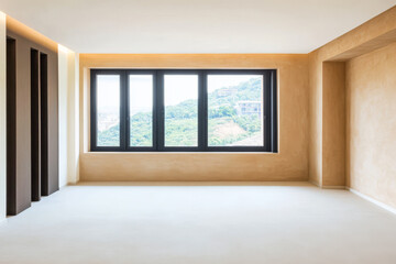 Modern interior of a spacious room with large windows and natural light in a hillside location