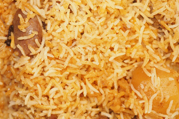 Flavorful rice dish featuring golden grains and tender pieces of meat