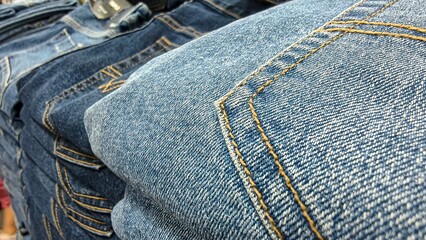 Close-up of neatly folded denim jeans showcasing texture and stitching